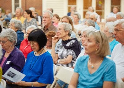 Residents applaud an education lecture at senior retirement community Lasell Village in Newton, MA, where lifelong learning is a way of life.