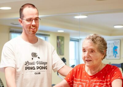 A female senior resident stays active working out with her personal trainer at continuous care retirement community Lasell Village in Newton, MA