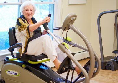 An elderly resident stays active in the fitness center of Newton, MA's senior living community Lasell Village.